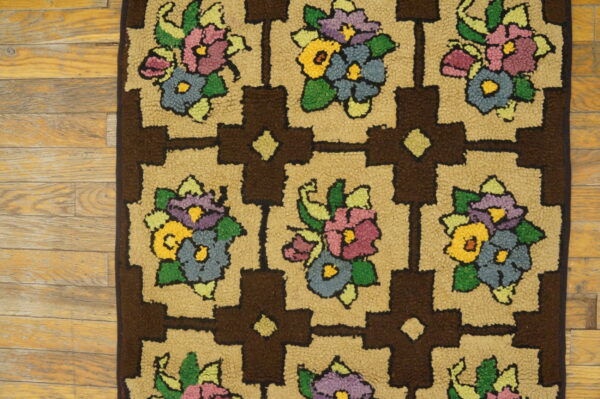 Close-up of a shaggy rug featuring colorful floral bouquets within a brown and tan geometric grid on wood floors.