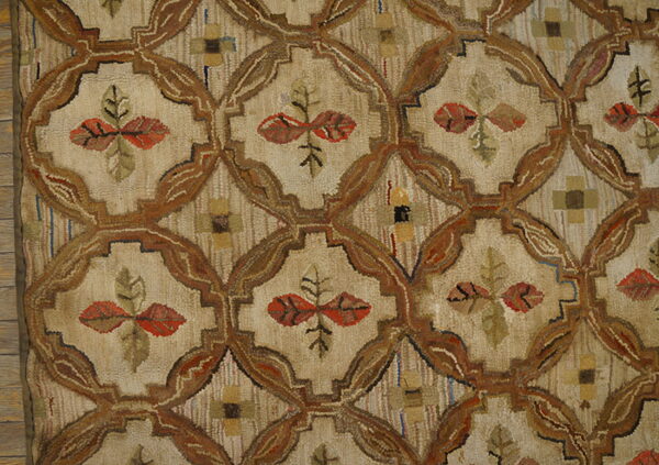 Muted, low-pile rug featuring a brown trellis pattern on beige, with rustic red and green leaf motifs.