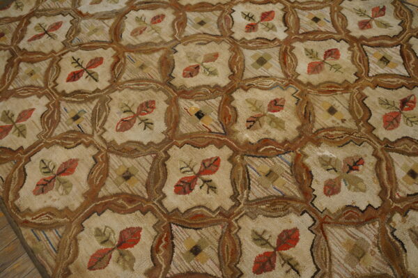 Highly textured beige rug featuring a repeating brown ogee lattice enclosing red and green floral motifs.