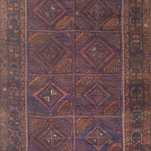 Intensely patterned low-pile rug with repeating geometric medallions in navy blue and reddish-brown.