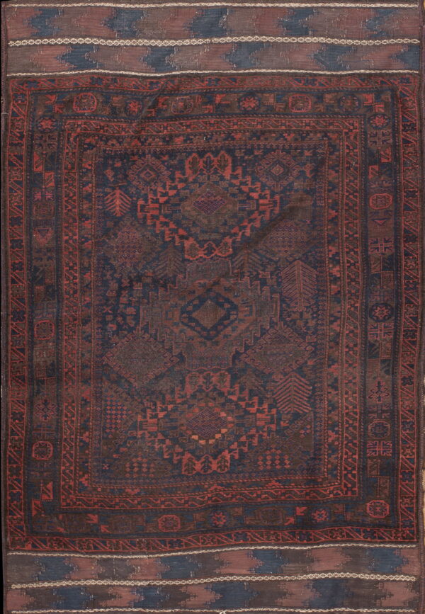 Dark blue and rust traditional geometric rug featuring low pile, multiple borders, and patterned flatwoven ends.
