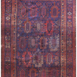Faded geometric rug featuring complex tribal designs in dark blue and deep red colors.