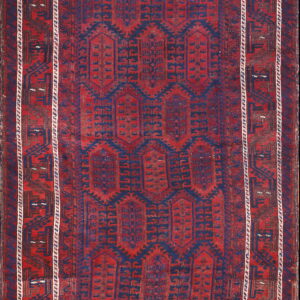 Geometric red and navy rug displaying repeating vertical medallions and complex dark borders with white accents.