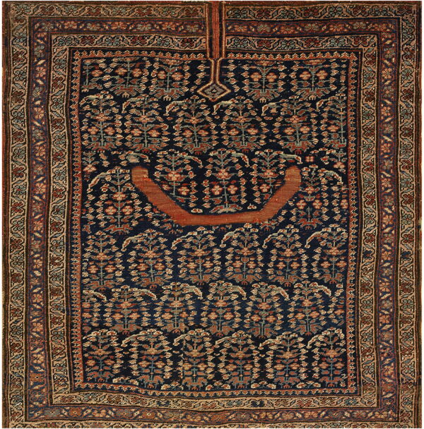 Dark blue prayer rug featuring repeating stylized floral motifs, a rust arch, and intricate borders.