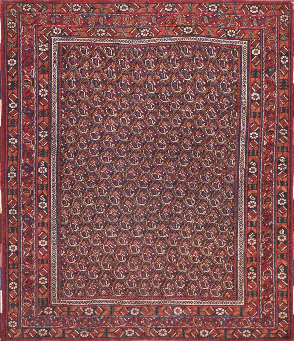 Red and blue traditional rug with a dense all-over pattern and multiple intricate geometric borders.