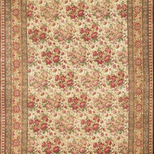 Beige rug featuring a dense red rose pattern, ornate tan borders, and visible calligraphy along the top edge.