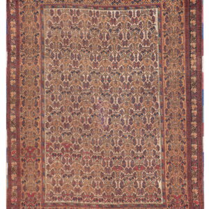 Rectangular low-pile rug with a detailed geometric field pattern in tan, maroon, and indigo colors.