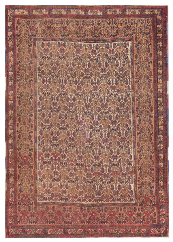 Rectangular low-pile rug with a detailed geometric field pattern in tan, maroon, and indigo colors.