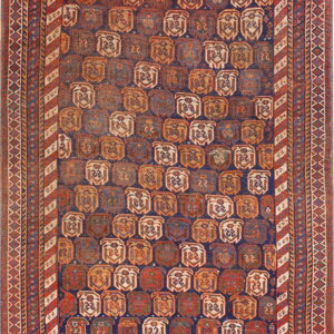 Geometric rug with an indigo field filled with repeating terracotta, beige, and blue medallions and striped borders.
