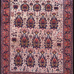 Traditional rug with an overall pattern of red and blue stylized palmettes on a cream background and red geometric borders.