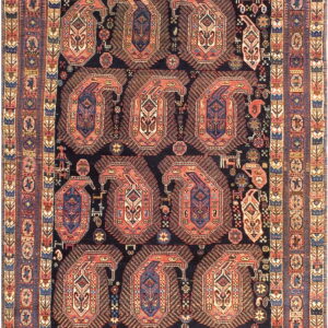 Navy blue rug densely patterned with nine large rust and blue boteh forms and complex geometric borders.