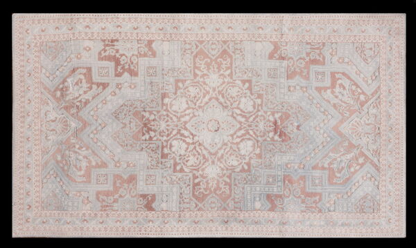 Muted traditional rug with a central medallion and complex borders in rose, gray, and cream tones.