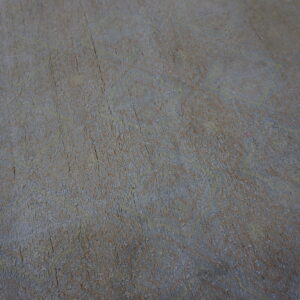 Textured, low-pile rug featuring a subtle, faded abstract pattern in gray, slate, and tan colors.