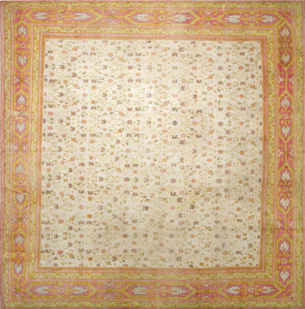 Cream rug featuring a delicate floral trellis pattern and a wide, detailed border in rose pink and sage green.