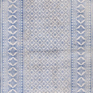 Light blue and white rug with a dense geometric field and multi-layered border design.