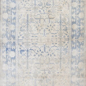 Faded cream and dusty blue rug with a distressed traditional field pattern and wide ornamental borders.