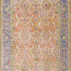 Traditional rug with an orange and peach field, surrounded by ornate blue and green floral borders.