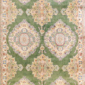 Long rug featuring repeating traditional floral medallions in cream and gold on a deep mossy green field.