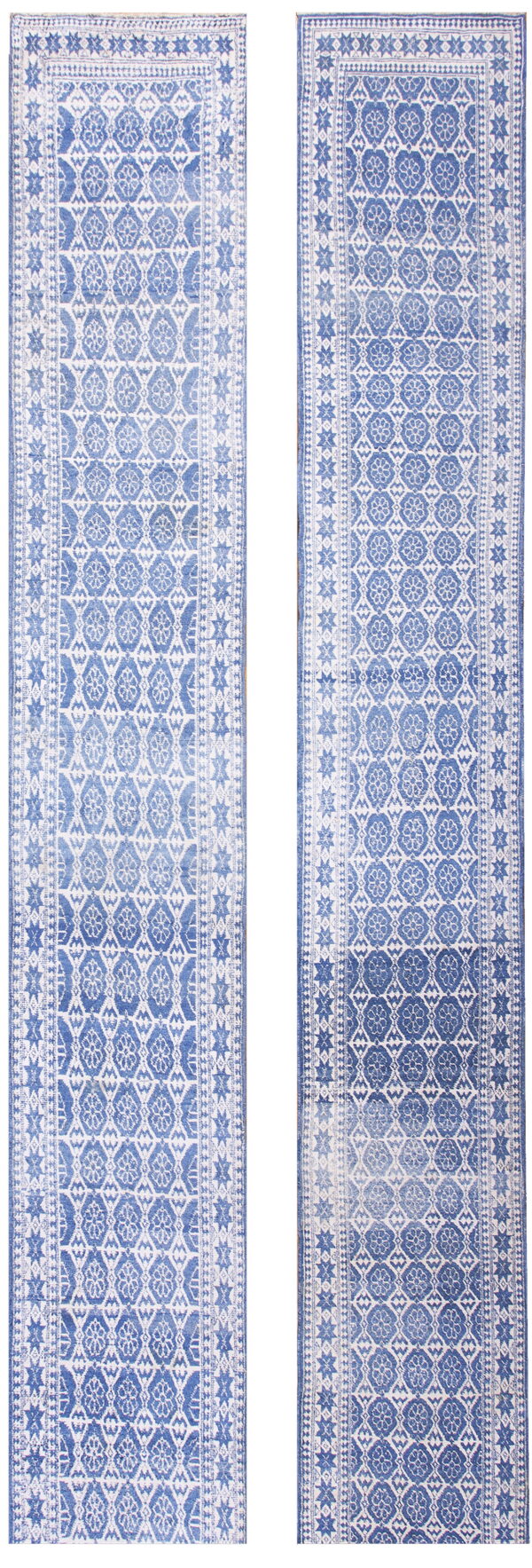 Two distressed indigo and white runner rugs with geometric medallions, star borders, and low pile.