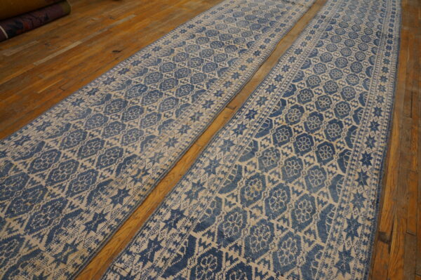 Two distressed blue and cream patterned runner rugs laid out on glossy wood flooring.