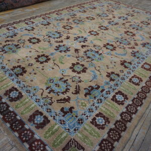 Beige high-pile rug featuring blue, brown, and green floral borders on rustic wooden planks.