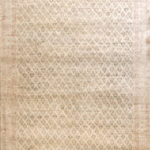 Narrow, distressed runner rug in cream and taupe featuring a repeating diamond lattice pattern.