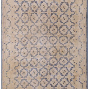 High-pile tan rug featuring an all-over dark blue geometric trellis pattern and thick blue borders.