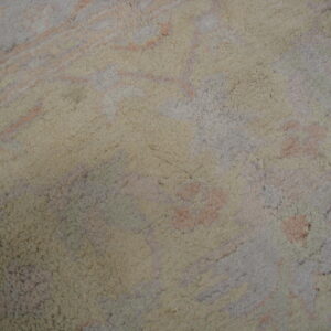 Shaggy rug surface detail with an abstract pattern of cream, pale pink, and soft gray colors.