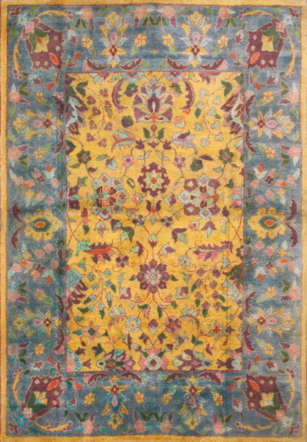 Ornate floral rug with a yellow center and a teal border, featuring maroon, pink, and green accents.