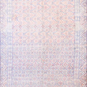 Low-pile rug with a repeating geometric and floral pattern in faded cream, light blue, and pink.