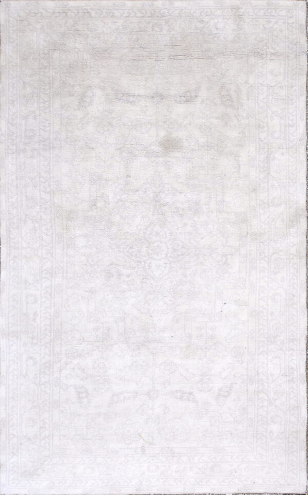 Light ivory rug with a subtly faded traditional border pattern and distressed texture.