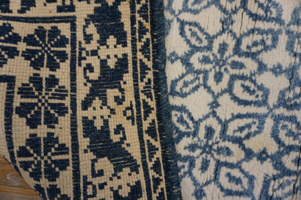 Detail of two blue and cream textures: a flatweave geometric pattern and a fluffy high-pile floral design.