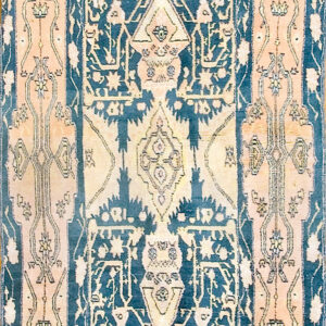 Navy blue rug with a central medallion and faded salmon and yellow intricate geometric designs.