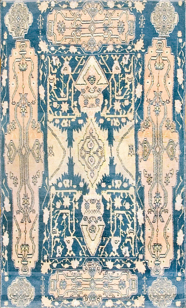 Navy blue rug with a central medallion and faded salmon and yellow intricate geometric designs.