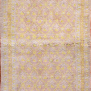 Rectangular high-pile rug featuring a pink background with bright yellow geometric and floral patterns.