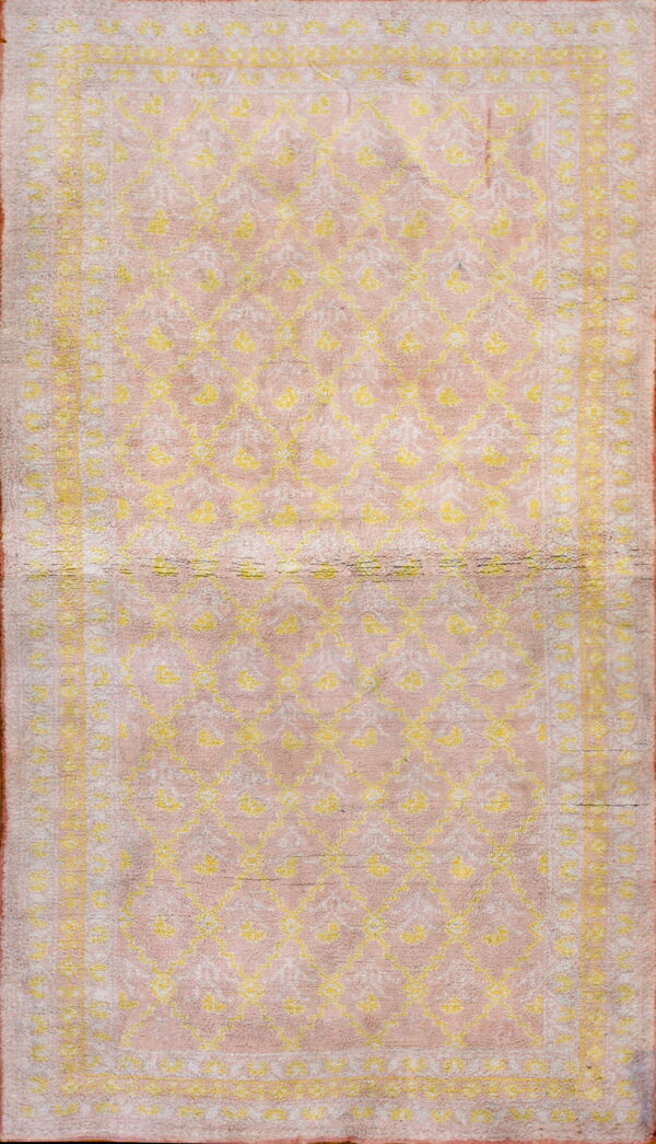 Rectangular high-pile rug featuring a pink background with bright yellow geometric and floral patterns.