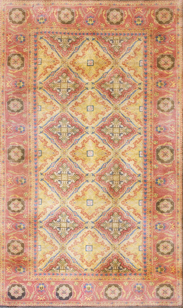 Distressed rug with a yellow field, red and blue geometric medallions, and a coral patterned border.