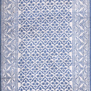 Full view of a blue and cream runner rug featuring an overall trellis design and multiple floral borders.