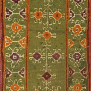 Green runner rug with alternating orange and maroon geometric patterns and striped borders.