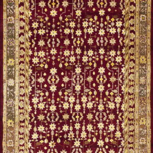 Maroon rug with dense gold star patterns and complex geometric borders in olive and yellow.