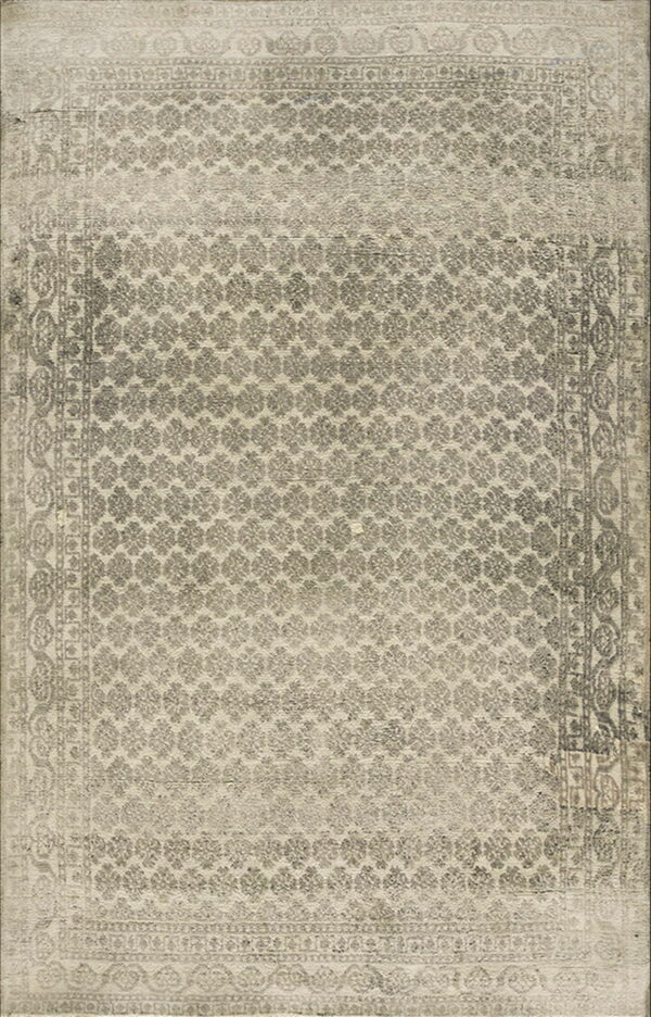 Muted gray and beige traditional rug featuring an all-over repeating medallion design and multiple patterned borders.