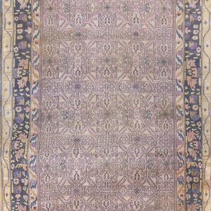 Mauve rug with a stylized geometric pattern and wide borders of dark blue and tan floral motifs.