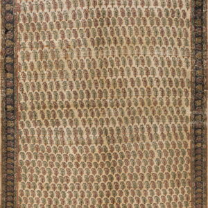 Muted beige rug with repeating rows of small red and green botanical motifs and a dark outer border.