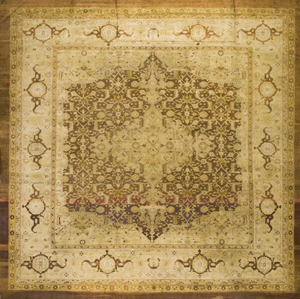 Intricate traditional square rug with a complex pattern in light beige, brown, and golden tones.