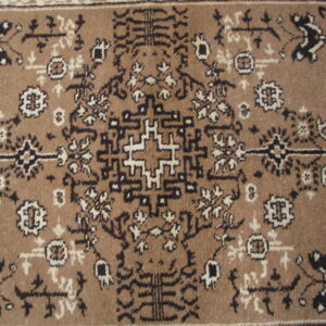 Tan rug with a dense traditional geometric and floral pattern in dark brown and cream.