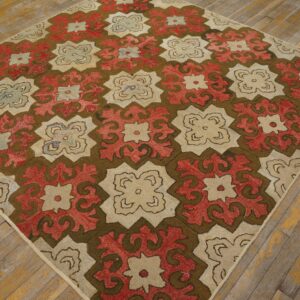 This textured rug features large, interlocking geometric medallions in dark brown, red, and beige on distressed wood planks.