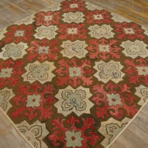 Repeating red, cream, and sage floral-geometric motifs fill this high-texture rug on rustic wooden flooring.