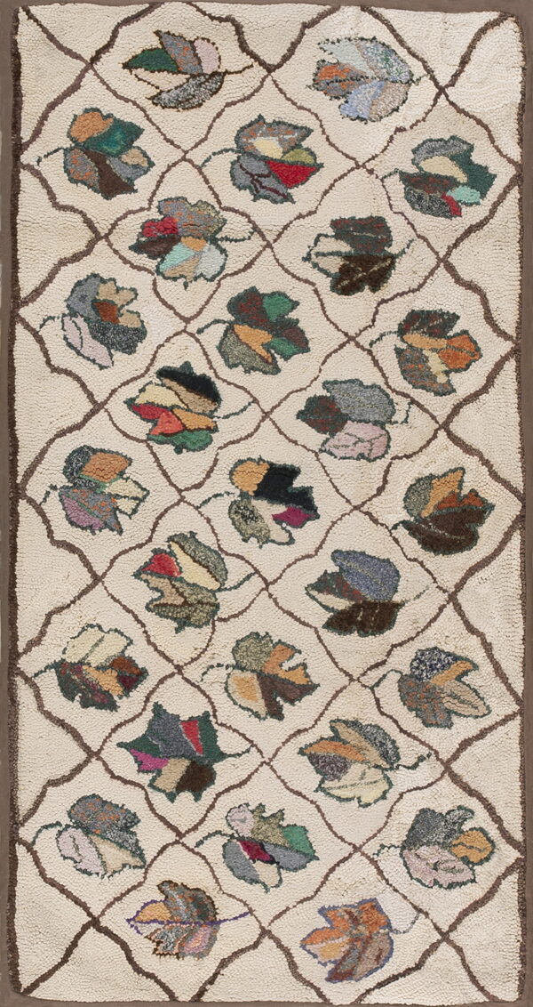 Textured cream rug with a brown geometric trellis and colorful, stylized patchwork leaf designs.