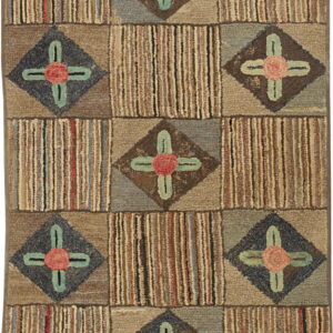 Muted hooked rug with a geometric block pattern alternating between vertical stripes and floral diamond motifs.