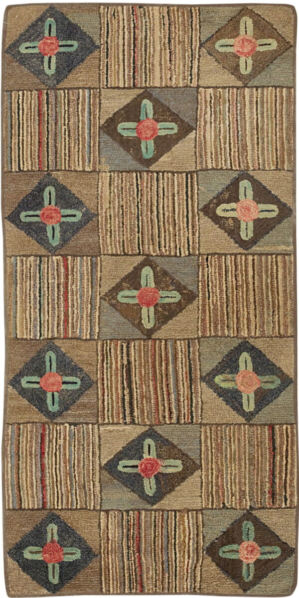 Muted hooked rug with a geometric block pattern alternating between vertical stripes and floral diamond motifs.